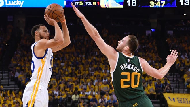 Golden State Warriors guard Stephen Curry (30) shoots the basketball against Utah Jazz forward Gordon Hayward (20) during the first quarter in Game 1.