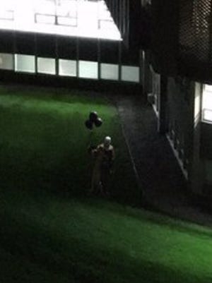 This photo was altered in Photoshop and created as a hoax. It shows an image of a clown standing in the shadows near Wilson Hall.
