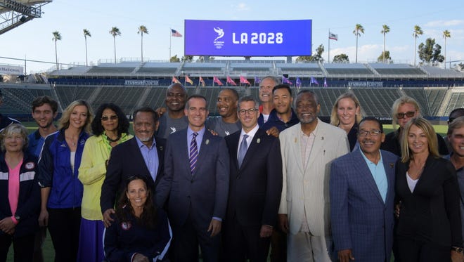 Jul 31, 2017; Carson, CA, USA; Los Angeles mayor Eric Garcetti (middle left) and LA2024 bid chairman Casey Wasserman (middle right) pose during a press conference to announce the awarding of the 2028 Olympics and Paralympics Games to Los Angeles at StubHub Center Stadium.
