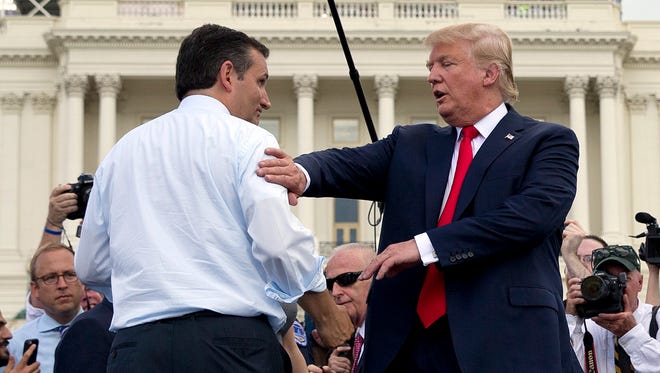 Donald Trump and Cruz greet each other on stage during a rally organized by Tea Party Patriots on Capitol Hill on Sept. 9, 2015, to oppose the Iran nuclear agreement.