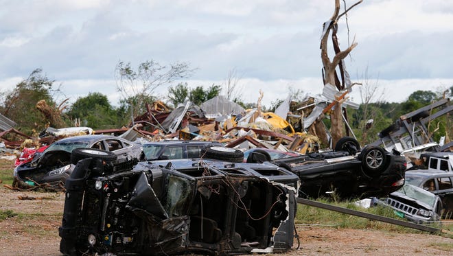 Cars and damaged material is seen piled up at a local car dealership that was destroyed when a large tornado hit the area near Canton, Texas on April 30, 2017.