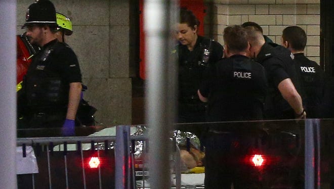A person is wheeled away on a stretcher at Victoria Railway Station close to the Manchester Arena, May 23, 2017, following reports of explosions where Ariana Grande had performed this evening.  Greater Manchester Police have have confirmed there are fatalities and warned people to stay away from the area.