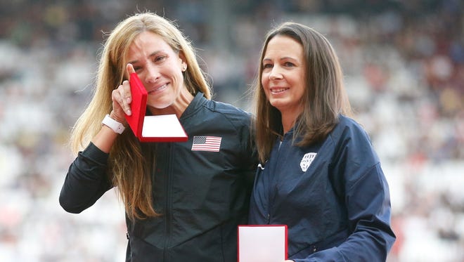 Kara Goucher of the USA, left, wipes away a tear as she stands with Britain's Jo Pavey on Day 2. Goucher, silver, and Pavey, bronze, received reallocated medals for the women's 10,000 at the World Championships in Osaka in 2007. The original silver medalist was stripped of her medal because of a positive doping test.