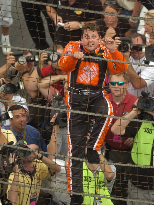 Tony Stewart climbs the fence to celebrate winning the Allstate 400 at the Brickyard in 2005.
