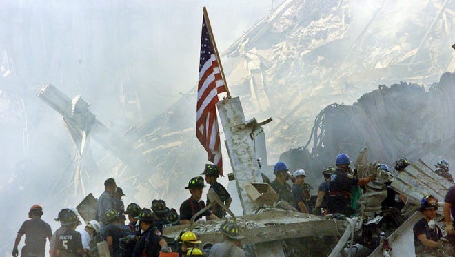 In this Sept. 13, 2001, file photo, an American flag flies over the rubble of the collapsed World Trade Center buildings in New York.