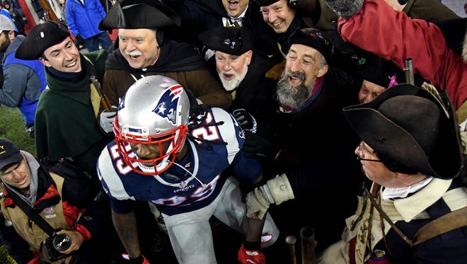Patriots running back LeGarrette Blount (29) celebrates with the End Zone Militia after scoring a touchdown during the third quarter.