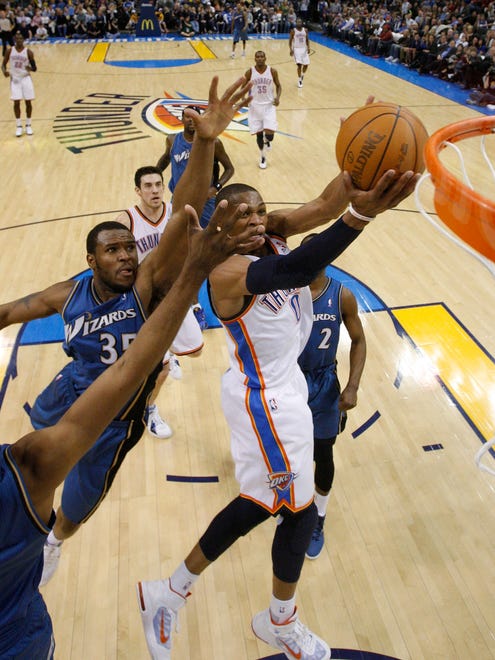 2011: Russell Westbrook goes up for a layup in front of Washington Wizards guard Nick Young and forward Trevor Booker.