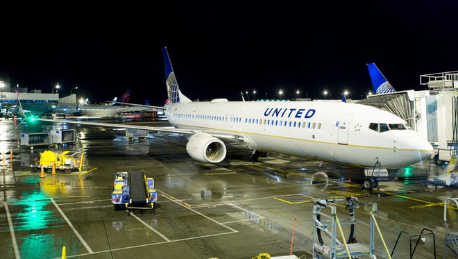 A United Airlines Boeing 737-900 rests at a gate at Seattle-Tacoma International Airport on March 12, 2016.