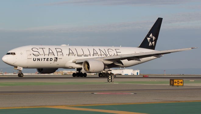 A United Airlines Boeing 777-200 - painted in a special Star Alliance livery - lands at San Francisco International Airport in October 2016.