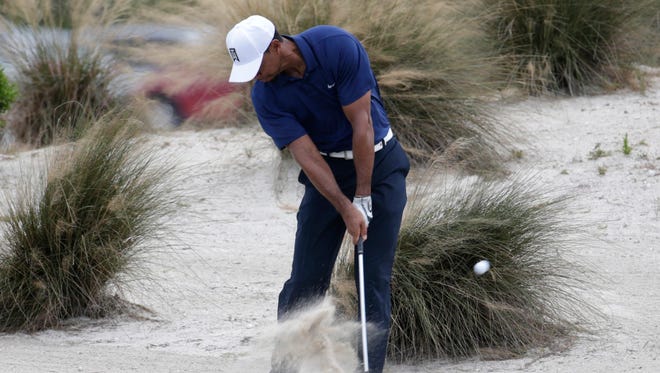 Tiger Woods hits off the seventh fairway waste bunker during Round 2 of the Hero World Challenge.