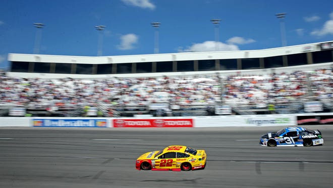 Eventual winner Joey Logano (22) and Ryan Newman (31) race during the Toyota Owners 400 at Richmond International Raceway on April 30.