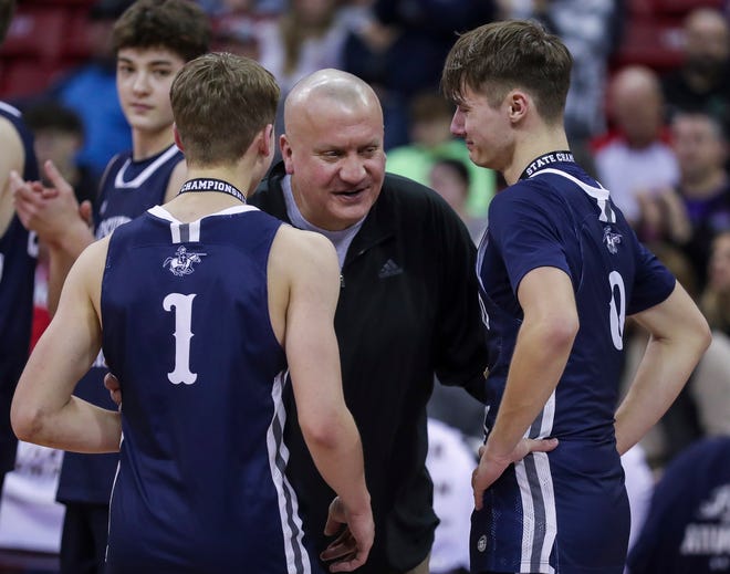 Columbus Catholic High School head coach Joe Konieczny (center) shares a moment with his sons, Mark (1) and Emmitt Konieczny (0), after they receive their individual medals after defeating Abundant Life Christian School in the Division 5 state championship game during the WIAA state boys basketball tournament on Saturday, March 16, 2024 at the Kohl Center in Madison, Wis. Columbus Catholic won the game, 81-75.