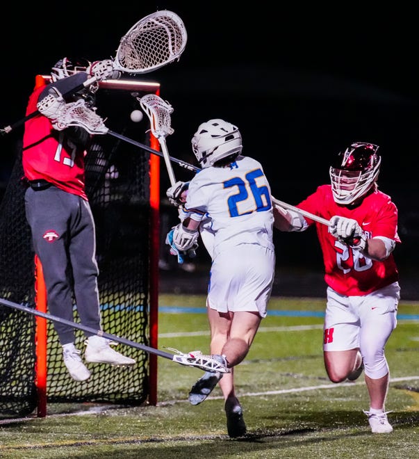 Mukwonago's Robert Spielmann (26) fires a shot at Homestead goalie Nick LaValle (19) during the lacrosse match at Mukwonago on Tuesday, March 19, 2024. The shot hit the left post and was no good. Homestead won 11-10.