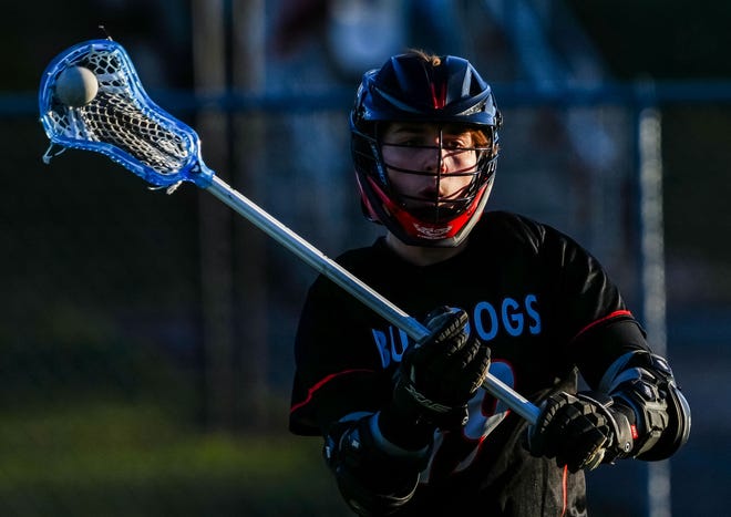 Cedarburg's Jake Nelson (19) makes a pass during the lacrosse match at Catholic Memorial on Wednesday, March 20, 2024.