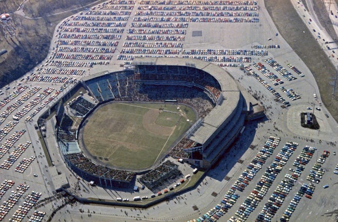 A westward-looking aerial of Milwaukee County Stadium during the Brewers' first opening day on April 7, 1970. It was also the season opener for the Brewers. This pre-game photo shows packed packing lots and lines of people entering the stadium. A crowd of 37,237 saw the Brewers fall to the California Angels 12-0.