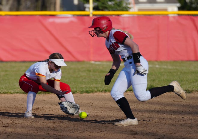 Sussex Hamilton's Maddie Palicka, right, races past as Divine Savior Holy Angels second baseman Tessa Grogan (1) scoops up a ground ball at Sussex Hamilton on Tuesday, April 9, 2024. Grogan tossed to first for the out.