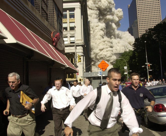 People run from the collapse of one of the twin towers of New York's World Trade Center.