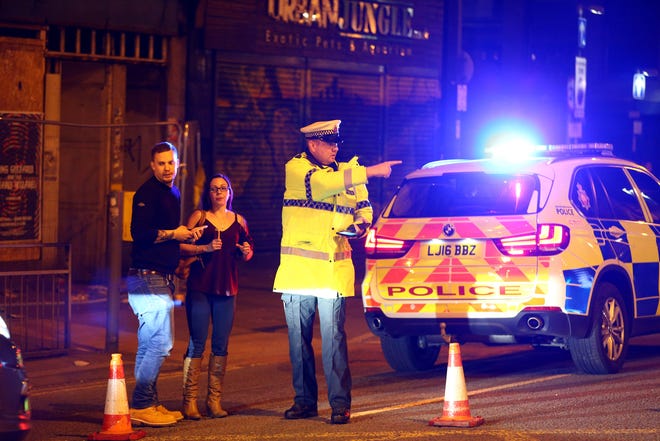 Police stand by a cordoned off street close to the Manchester Arena on May 22, 2017 in Manchester, England.  There have been reports of explosions at Manchester Arena where Ariana Grande had performed this evening.  Greater Manchester Police have have confirmed there are fatalities and warned people to stay away from the area.