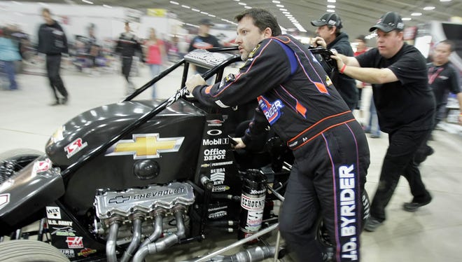 Stewart and his crew push his midget car to the track before he competes in the 2012 Race of Champions at the Chili Bowl Midget Nationals in Tulsa, Okla.