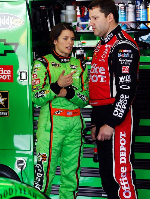 Danica Patrick (left) talks with Stewart during practice for the 2012 Daytona 500.  2012 was Patrick's first season as a driver for Stewart's team, Stewart-Haas Racing,