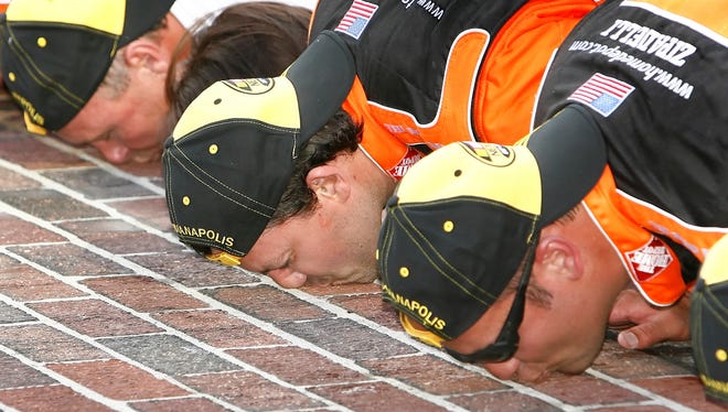 Stewart, an Indiana native, kisses the bricks after winning the 14th running of the Allstate 400 at the Indianapolis Motor Speedway in July of 2007.