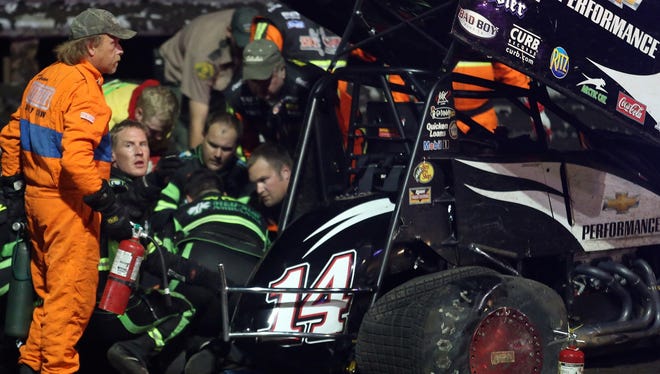 Tony Stewart, not visible, is checked over by medics after being involved in a four-car wreck at Southern Iowa Speedway in Oskaloosa.