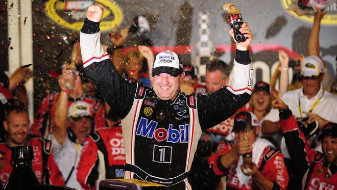 Tony Stewart celebrates winning the last year's Coke Zero 400 at Daytona International Speedway.