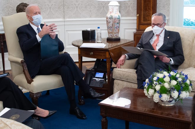 US President Joe Biden hosts a meeting with Senate Democrats, including Senate Majority Leader Chuck Schumer, right, about a COVID-19 relief bill in the Oval Office of the White House in Washington, DC, February 3, 2021.