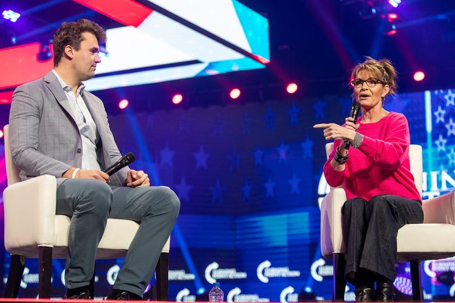 Charlie Kirk, left, and Sarah Palin, former governor of Alaska, right, hold a discussion during the second day of AmericaFest 2021 hosted by Turning Point USA on Sunday, Dec. 19, 2021, in Phoenix.